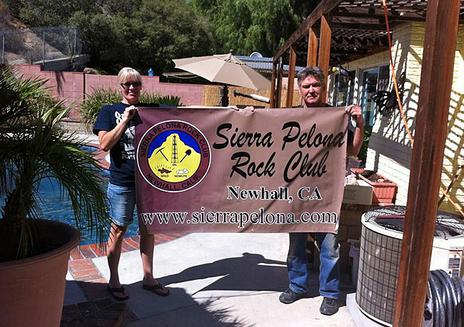 Trina and Bill hloding up the club's new banner ready for Lombardis.