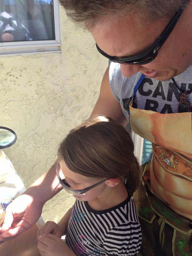 Greg teaching Olive how to polish her plasma agate.