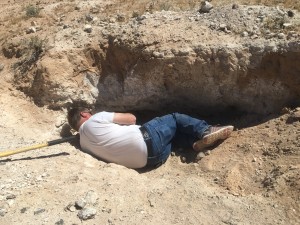 Larry laying digging in a whole for travertine